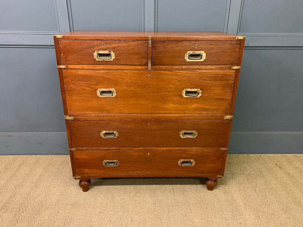 A Victorian teak two-part military campaign chest featuring flush brass handles, brass corner brackets, and turned legs. View III