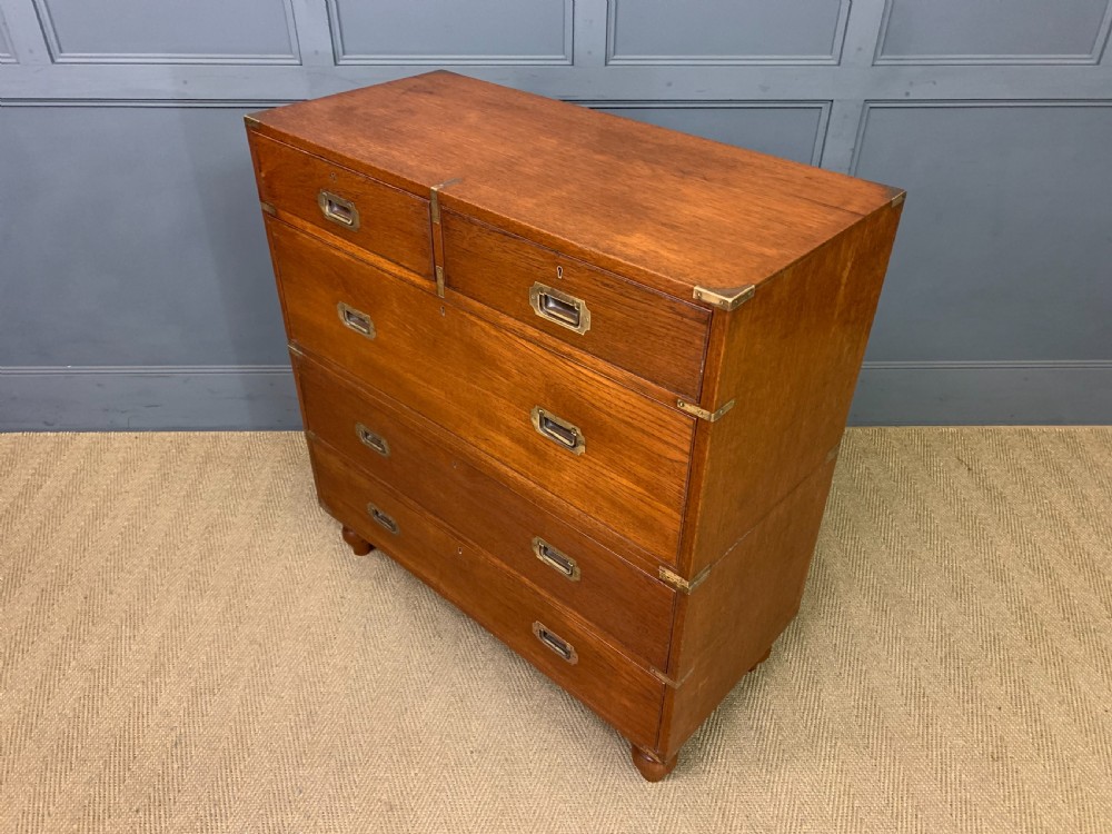 A Victorian teak two-part military campaign chest featuring flush brass handles, brass corner brackets, and turned legs. View XIII