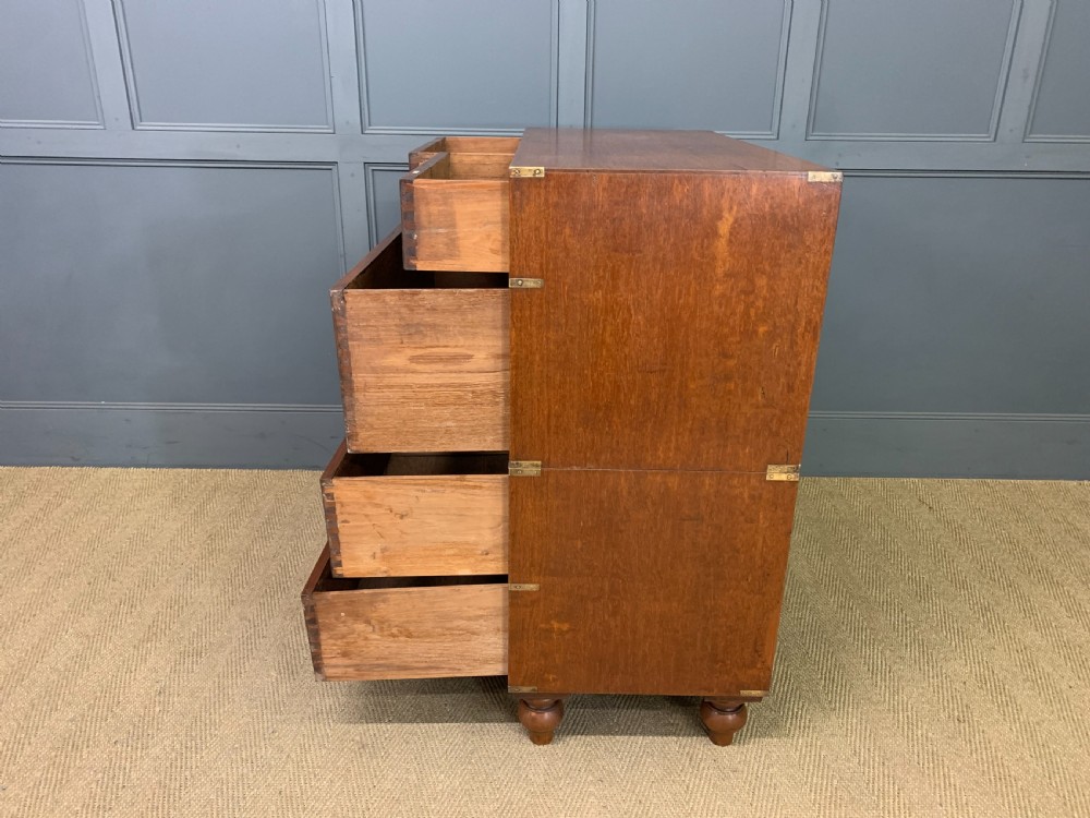 A Victorian teak two-part military campaign chest featuring flush brass handles, brass corner brackets, and turned legs. View XV