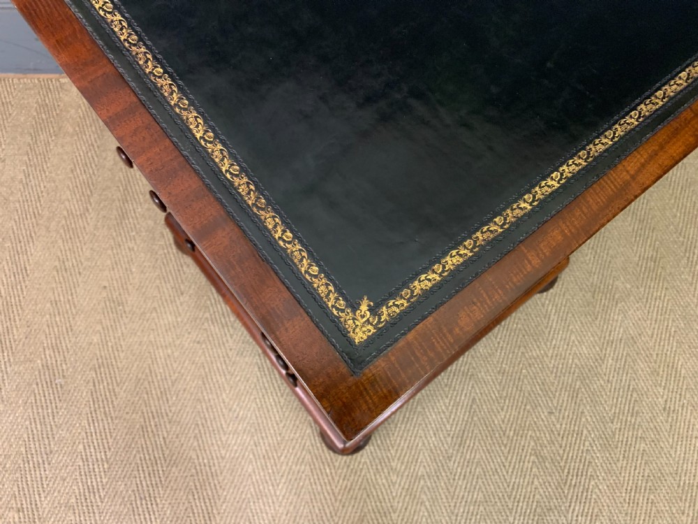 An early Victorian mahogany Davenport desk with a sloped leather writing surface and side drawers. View XVIII