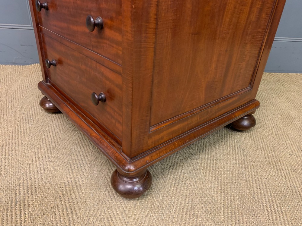 An early Victorian mahogany Davenport desk with a sloped leather writing surface and side drawers. View XXI
