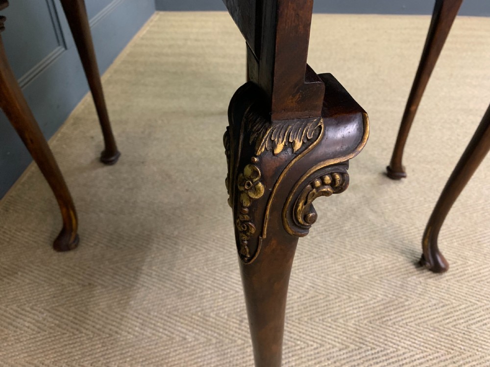 A burr walnut drop flap table featuring carved cabriole legs with leaf decoration, a single drawer with brass pull, and two rounded drop leaves. View X