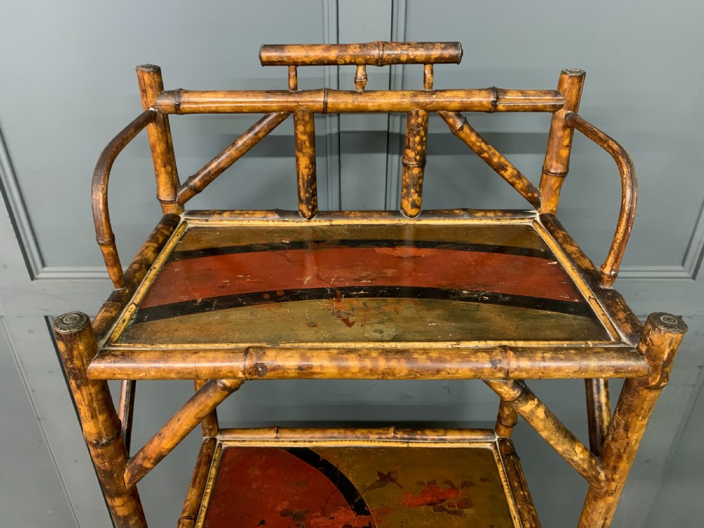 A late Victorian three-tiered bamboo whatnot stand featuring lacquer wood panel surfaces and vertical lower divisions. View IV