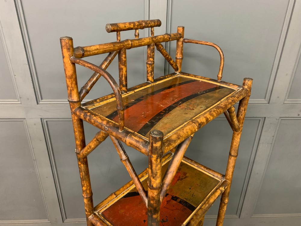 A late Victorian three-tiered bamboo whatnot stand featuring lacquer wood panel surfaces and vertical lower divisions. View XI