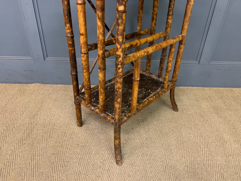 A late Victorian three-tiered bamboo whatnot stand featuring lacquer wood panel surfaces and vertical lower divisions. View XII