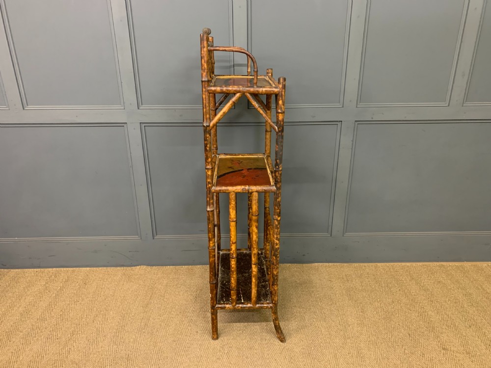 A late Victorian three-tiered bamboo whatnot stand featuring lacquer wood panel surfaces and vertical lower divisions. View XIII