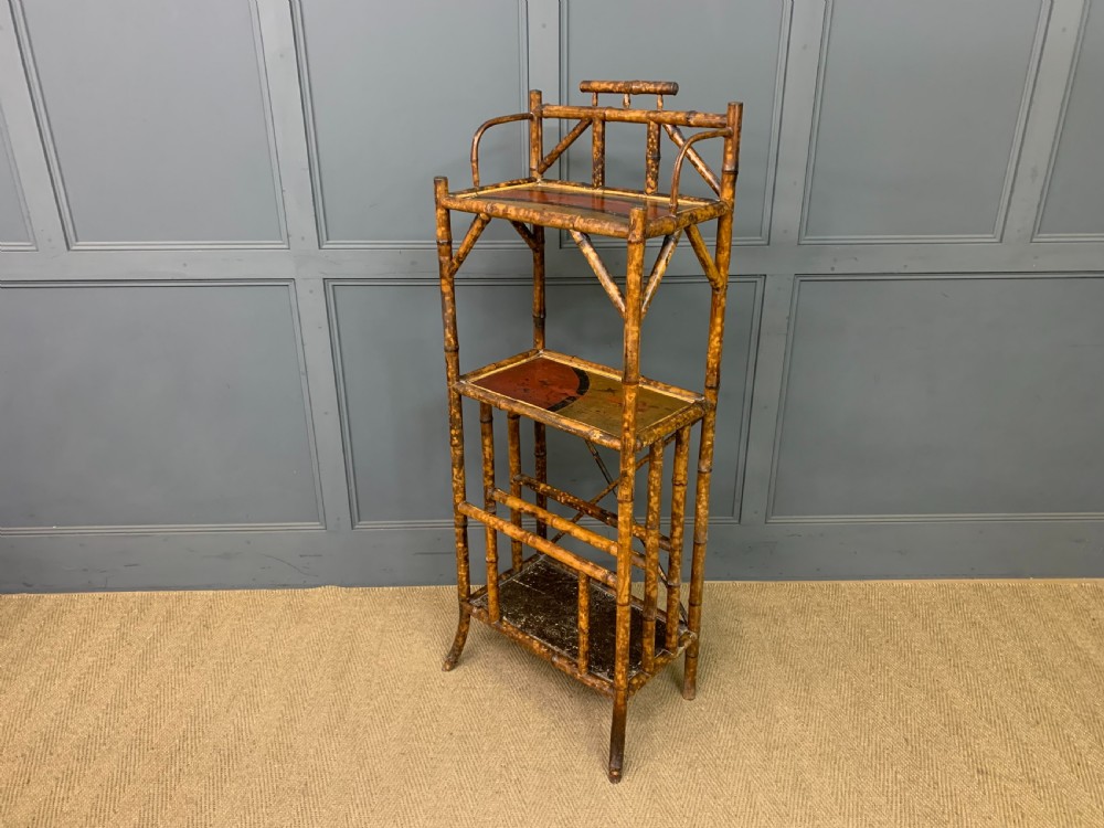 A late Victorian three-tiered bamboo whatnot stand featuring lacquer wood panel surfaces and vertical lower divisions. View XIV
