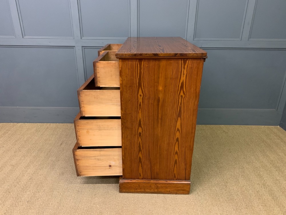 A late Victorian pitch pine chest of drawers featuring ebonised geometric dot inlay details and brass drop handles. View XIII