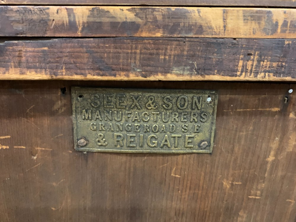 A late Victorian pitch pine chest of drawers featuring ebonised geometric dot inlay details and brass drop handles. View XIV
