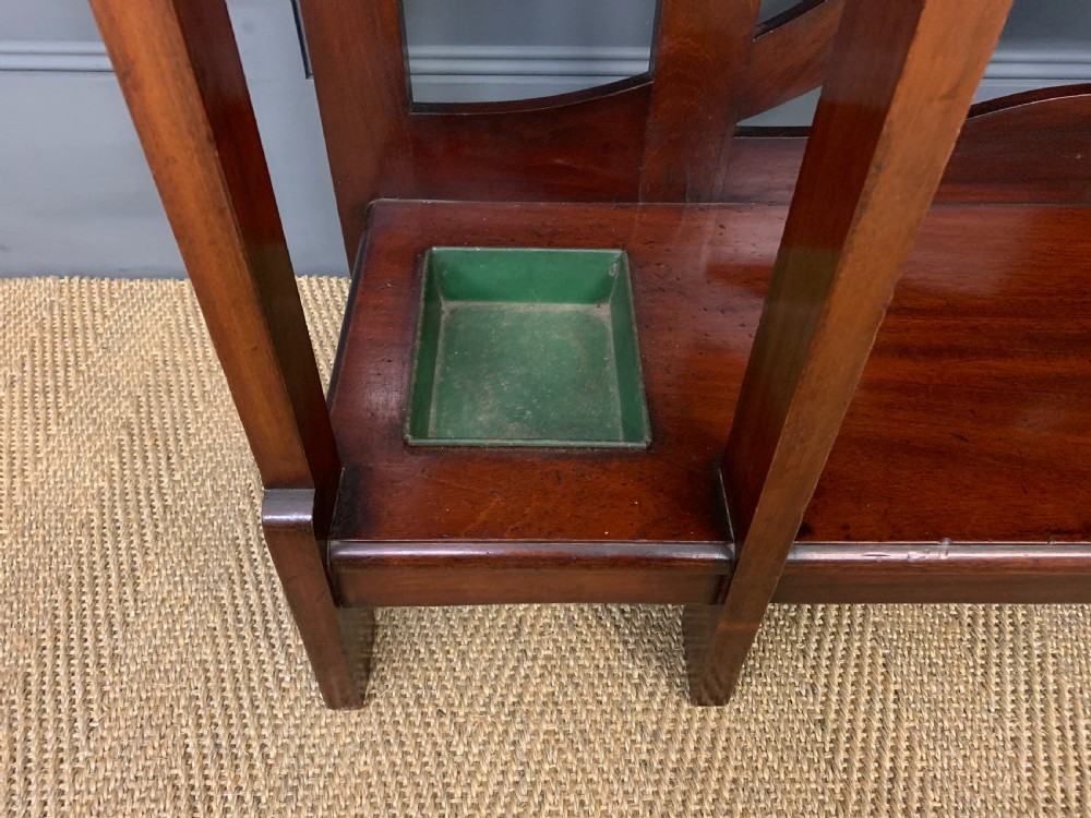 An Arts and Crafts inlaid mahogany hall stand featuring an arched central mirror, coat pegs, marble surface, and integrated umbrella racks. View IX