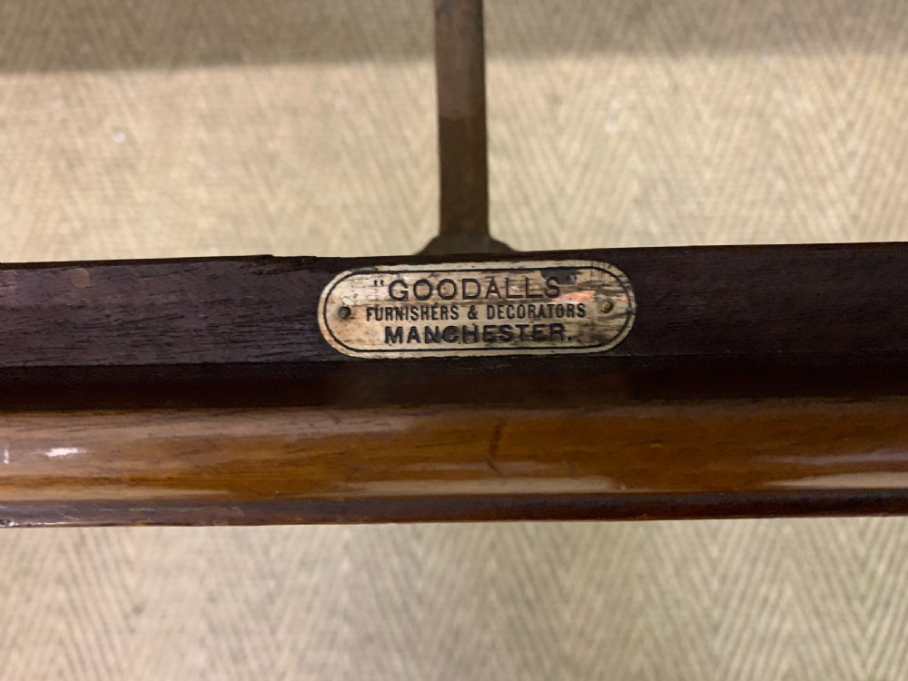 A carved mahogany Chippendale style settee featuring four pierced splats, scrolled arms, a striped fabric seat, and ball-and-claw feet. View II