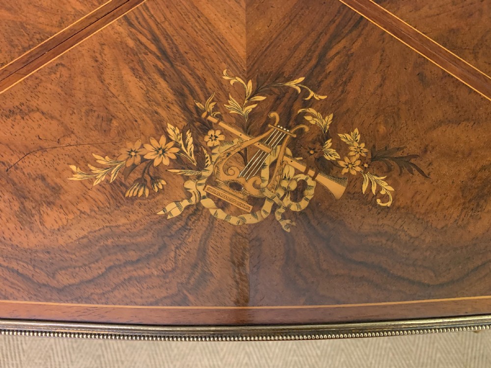 An Edwardian inlaid rosewood envelope card table featuring cabriole legs with brass mounts, a single drawer, and top flaps decorated with floral and musical instrument marquetry. View IV