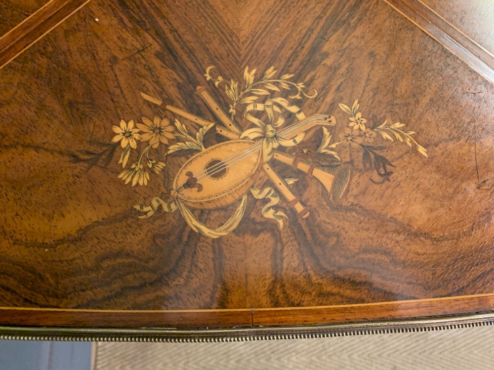 An Edwardian inlaid rosewood envelope card table featuring cabriole legs with brass mounts, a single drawer, and top flaps decorated with floral and musical instrument marquetry. View VI