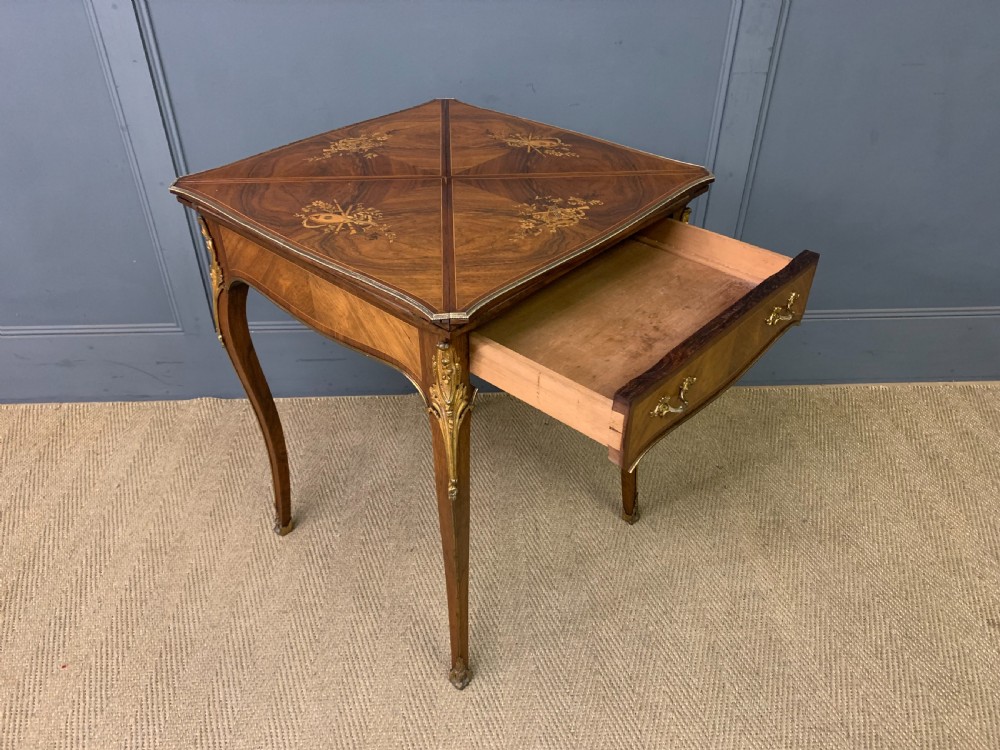 An Edwardian inlaid rosewood envelope card table featuring cabriole legs with brass mounts, a single drawer, and top flaps decorated with floral and musical instrument marquetry. View XIII