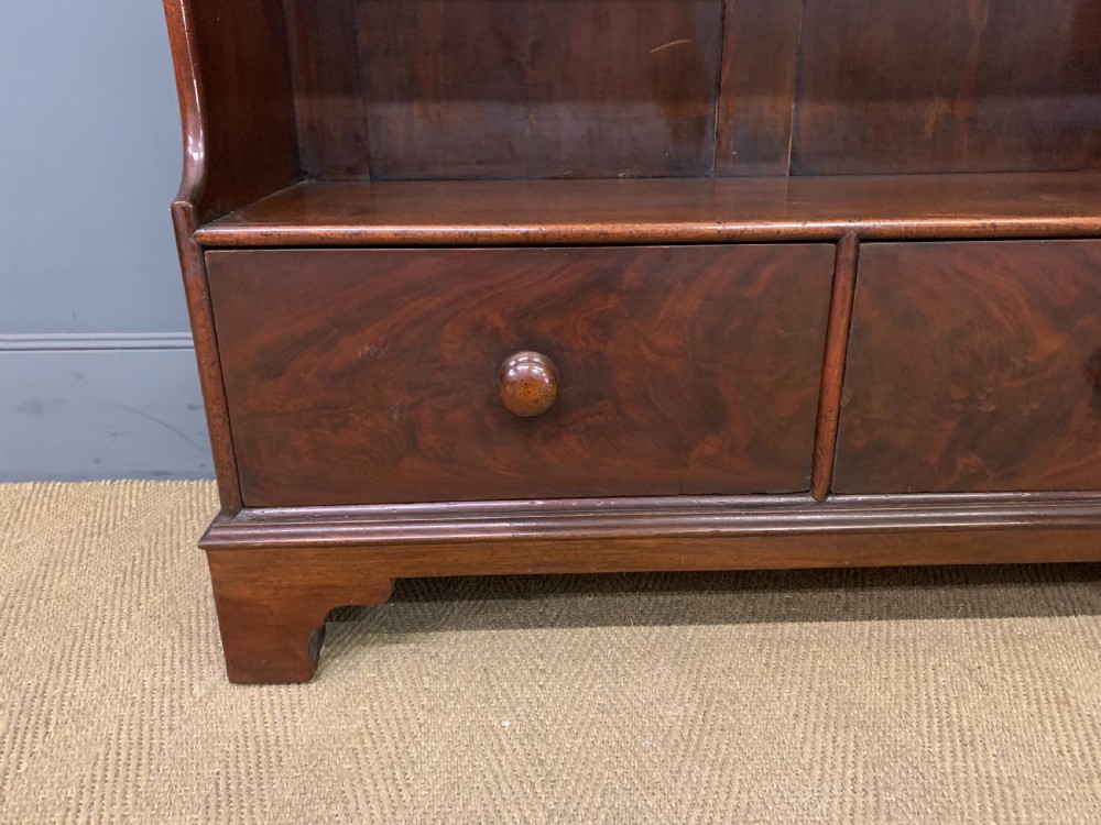 Victorian mahogany waterfall open bookcase featuring graduated shelves, shaped sides, and two lower drawers with turned wooden handles. View III