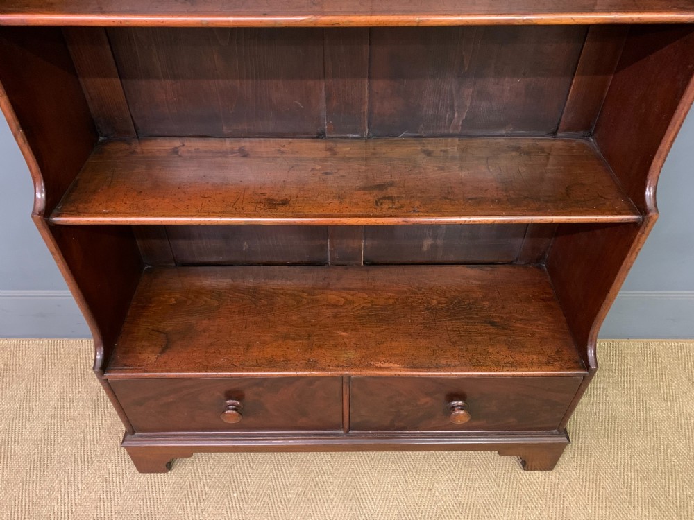 Victorian mahogany waterfall open bookcase featuring graduated shelves, shaped sides, and two lower drawers with turned wooden handles. View IV
