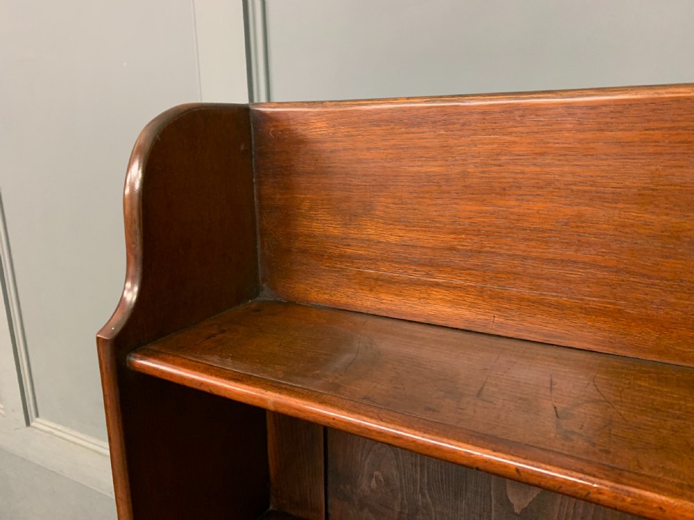 Victorian mahogany waterfall open bookcase featuring graduated shelves, shaped sides, and two lower drawers with turned wooden handles. View V
