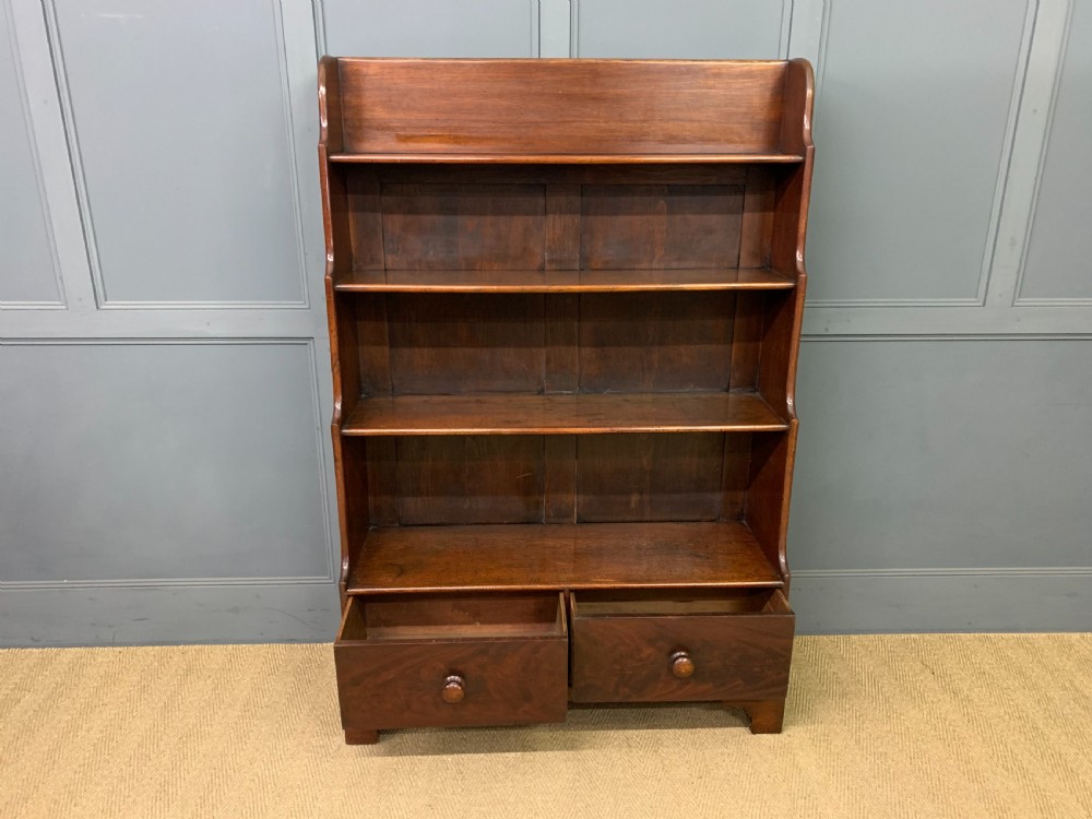 Victorian mahogany waterfall open bookcase featuring graduated shelves, shaped sides, and two lower drawers with turned wooden handles. View VI