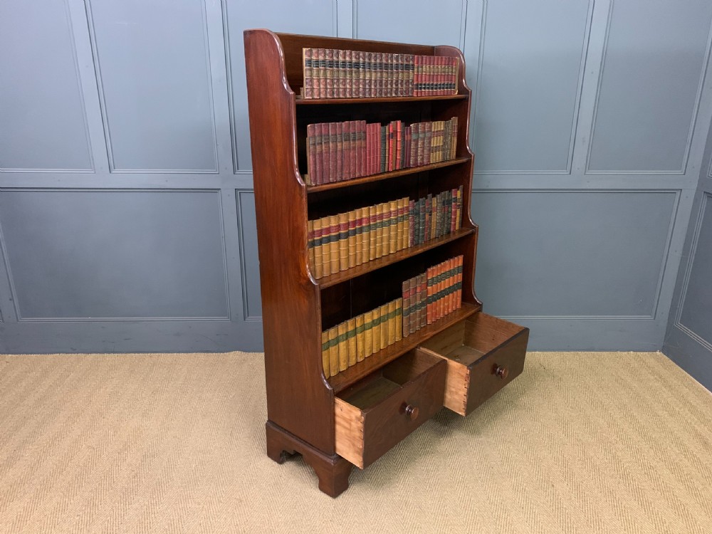 Victorian mahogany waterfall open bookcase featuring graduated shelves, shaped sides, and two lower drawers with turned wooden handles. View IX