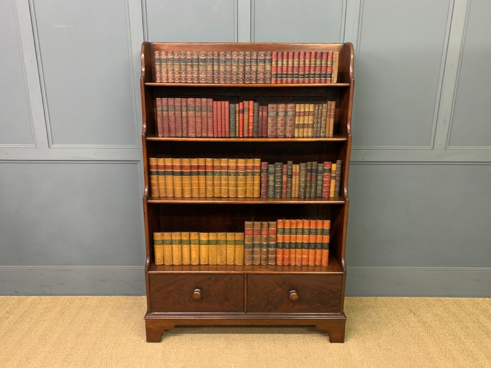 Victorian mahogany waterfall open bookcase featuring graduated shelves, shaped sides, and two lower drawers with turned wooden handles. View X