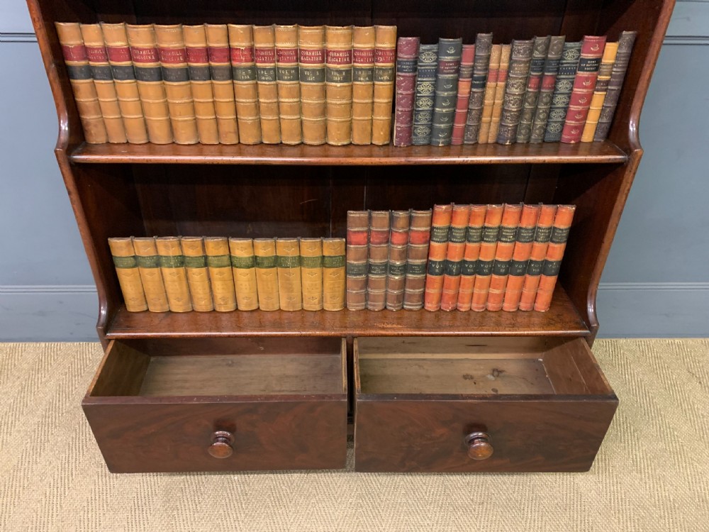Victorian mahogany waterfall open bookcase featuring graduated shelves, shaped sides, and two lower drawers with turned wooden handles. View XI