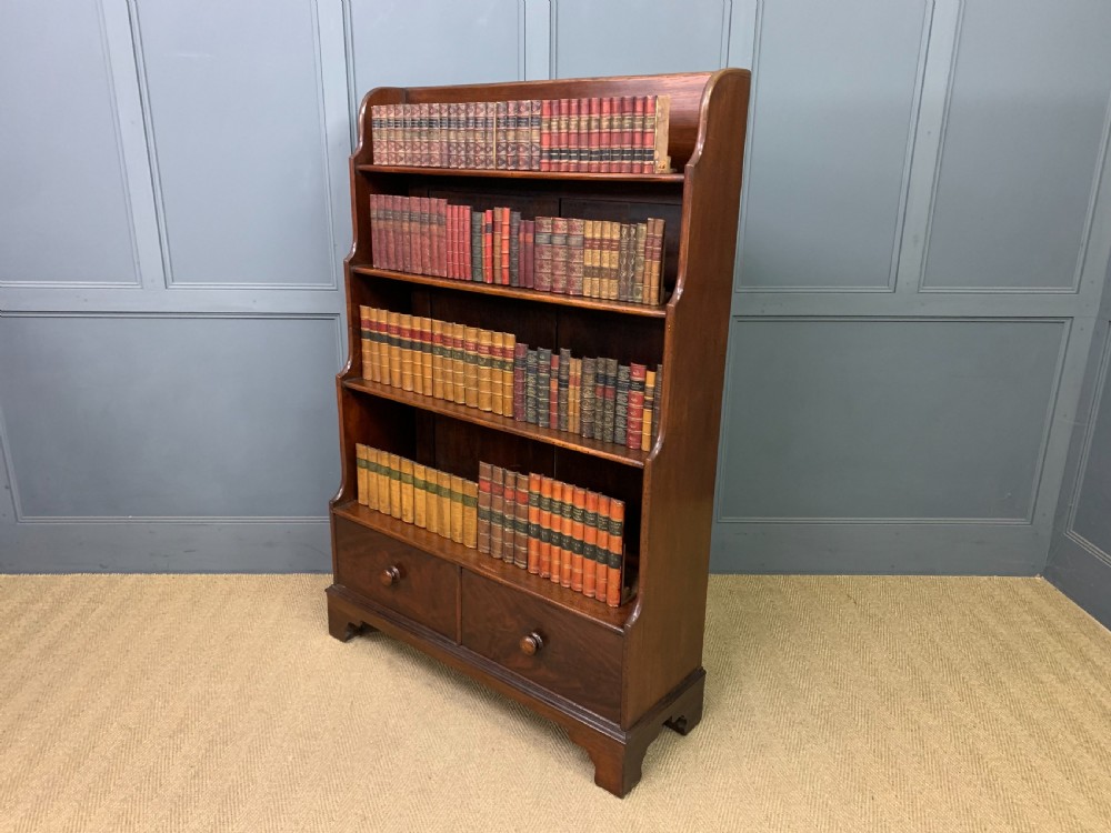 Victorian mahogany waterfall open bookcase featuring graduated shelves, shaped sides, and two lower drawers with turned wooden handles. View XII