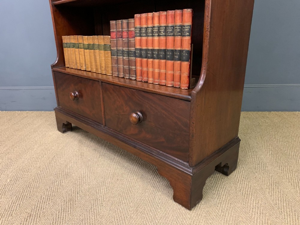 Victorian mahogany waterfall open bookcase featuring graduated shelves, shaped sides, and two lower drawers with turned wooden handles. View XIII