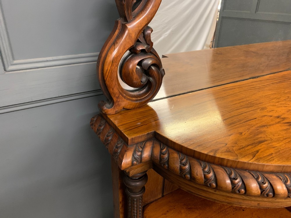 A Victorian burr walnut chiffonier featuring open side display shelves, mirrored central cabinet doors, and an ornate carved mirror frame cresting. View VIII