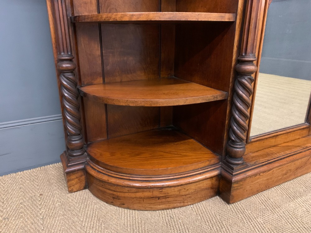 A Victorian burr walnut chiffonier featuring open side display shelves, mirrored central cabinet doors, and an ornate carved mirror frame cresting. View XI