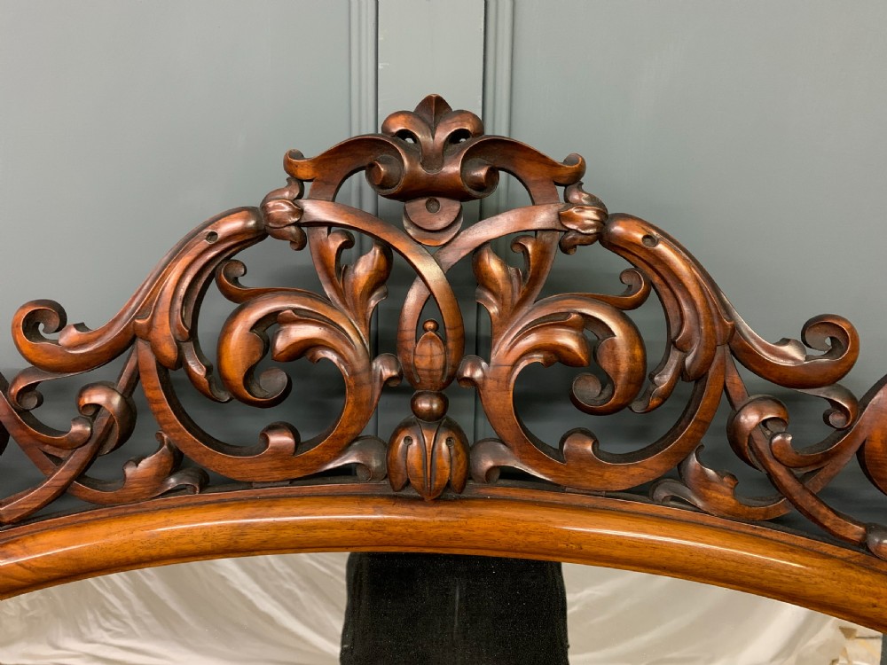 A Victorian burr walnut chiffonier featuring open side display shelves, mirrored central cabinet doors, and an ornate carved mirror frame cresting. View XIII