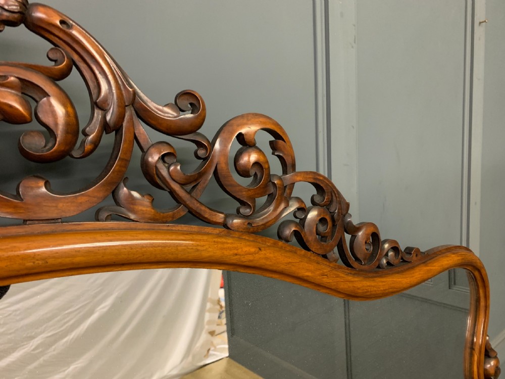 A Victorian burr walnut chiffonier featuring open side display shelves, mirrored central cabinet doors, and an ornate carved mirror frame cresting. View XIV
