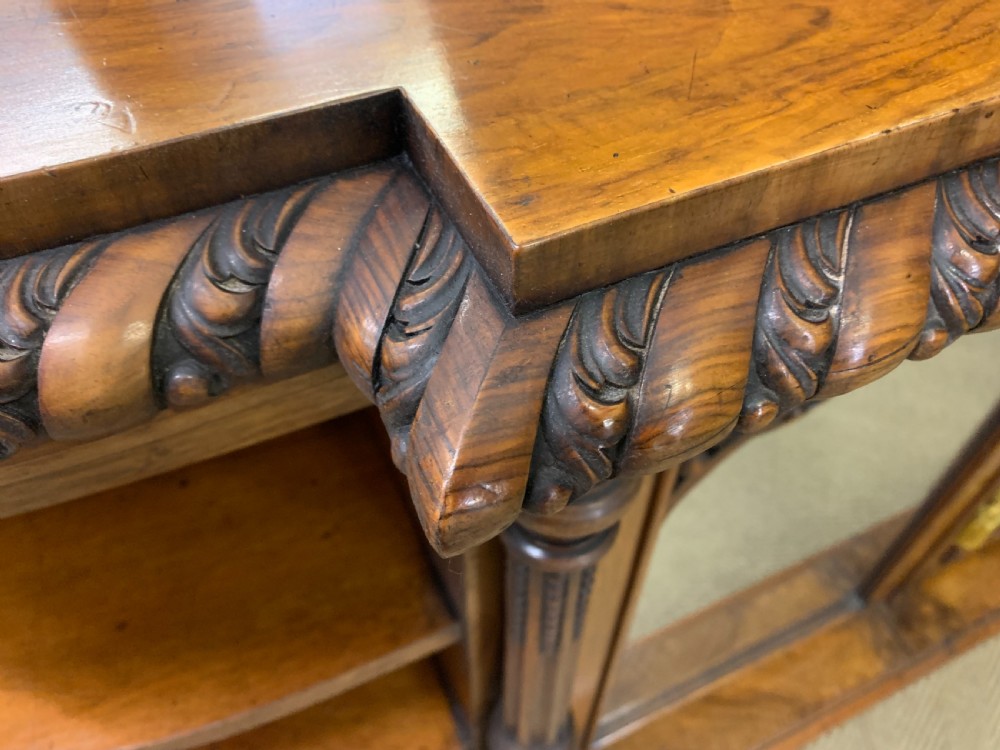 A Victorian burr walnut chiffonier featuring open side display shelves, mirrored central cabinet doors, and an ornate carved mirror frame cresting. View XX