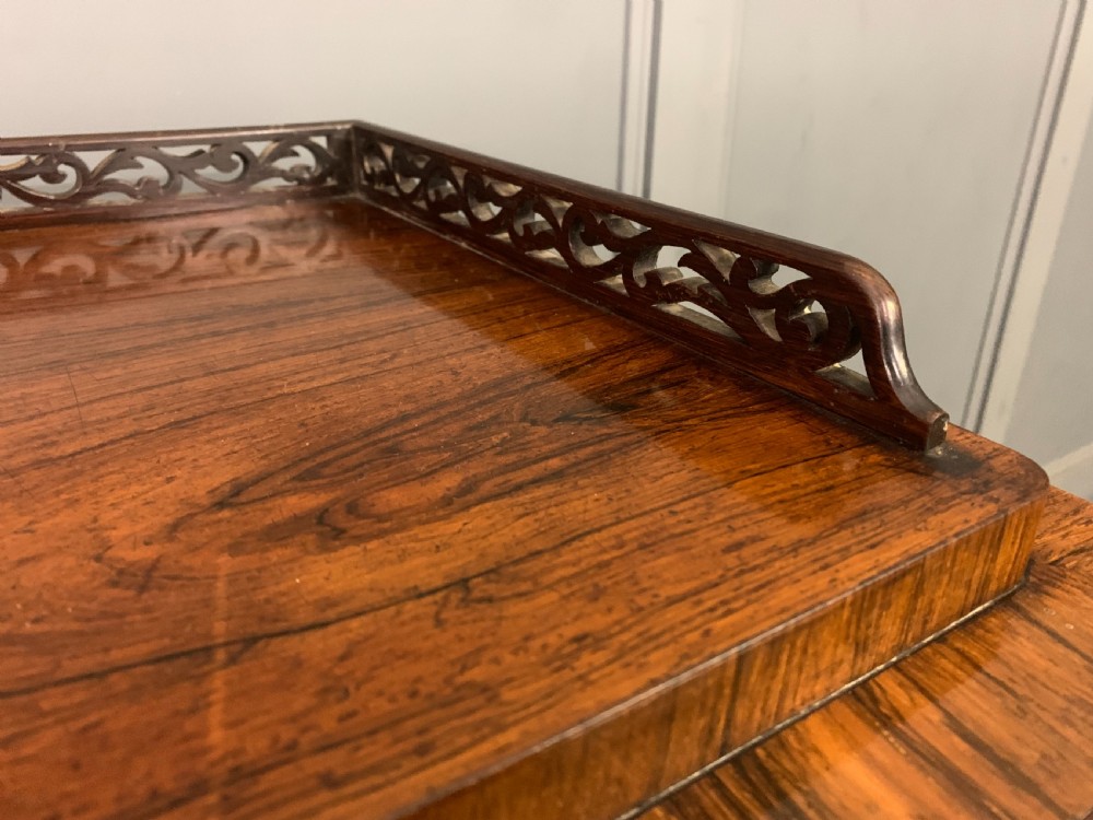 A tall Victorian rosewood bookcase cabinet featuring a single glazed door with carved scrollwork borders and a fretwork top gallery. View X
