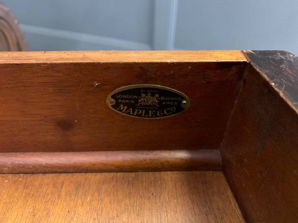 A carved mahogany writing table with a three-section inset leather top, detailed frieze carvings, and carved legs with claw feet. View XXI