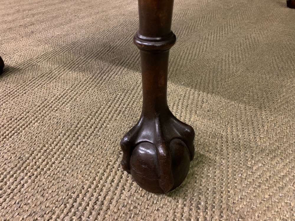 A flame mahogany Chippendale style writing desk featuring a shaped top, five brass-handled drawers, and carved cabriole legs with ball and claw feet. View XIV