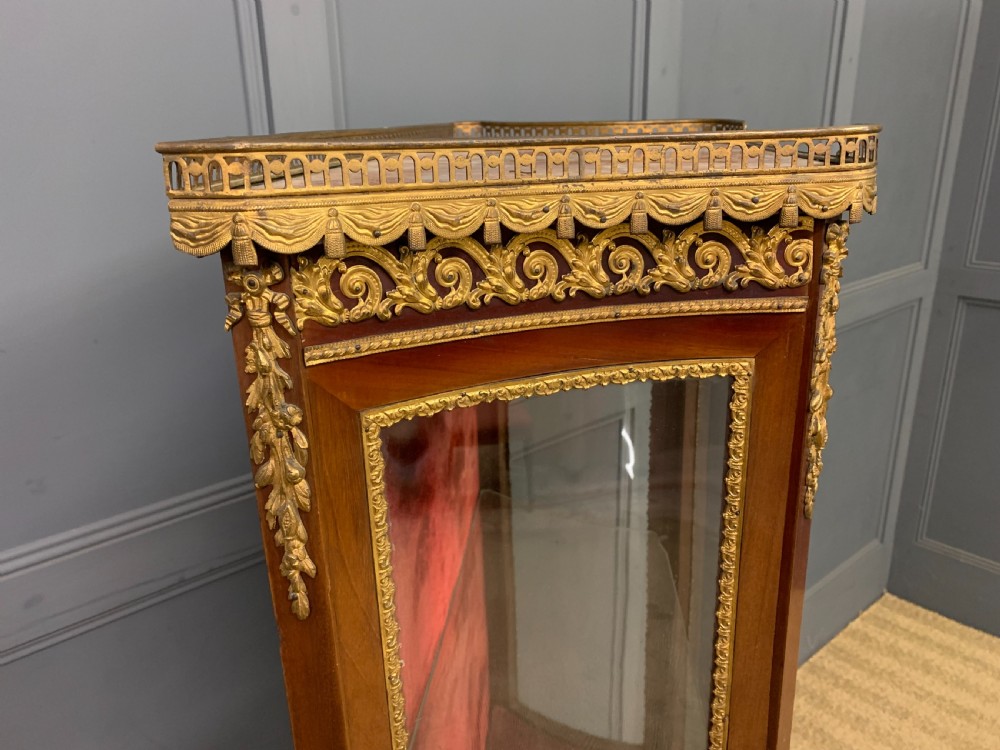 A French Louis XV style mahogany vitrine featuring a curved glazed door, gilt-bronze mounts, hand-painted lower panel depicting romantic figures, and a red velvet interior. View XI