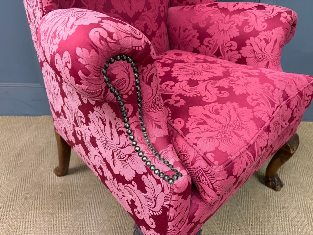 Late nineteenth-century wingback armchair upholstered in red damask fabric, featuring carved walnut cabriole legs with claw and ball feet. View IX
