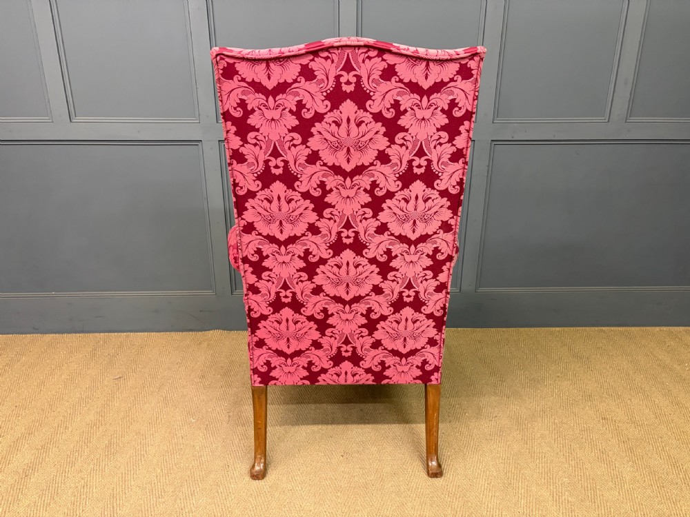 Late nineteenth-century wingback armchair upholstered in red damask fabric, featuring carved walnut cabriole legs with claw and ball feet. View XIII