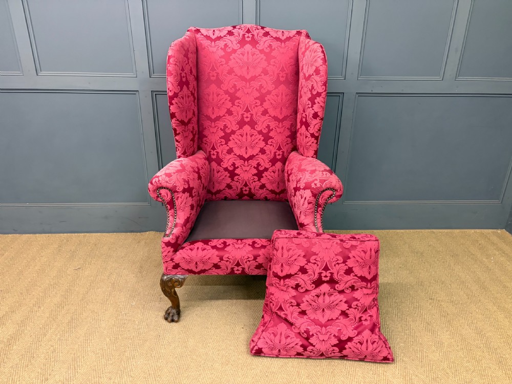 Late nineteenth-century wingback armchair upholstered in red damask fabric, featuring carved walnut cabriole legs with claw and ball feet. View XIV