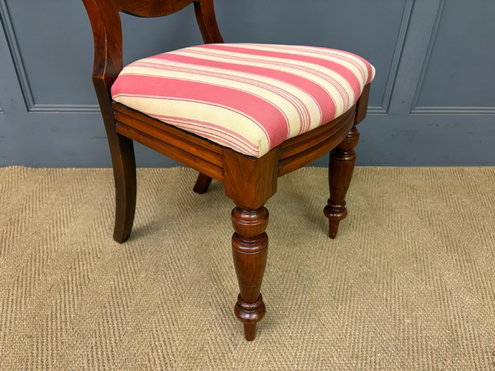 A set of ten Victorian mahogany balloon back dining chairs featuring turned front legs and red and cream striped upholstered seats. View XI