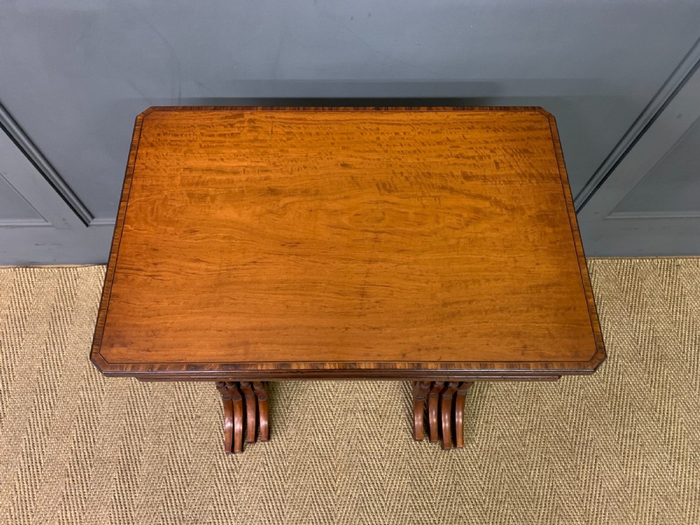 A nest of four graduated wooden tables featuring figure-grained satinwood tops with inlaid borders and slender turned legs. View III