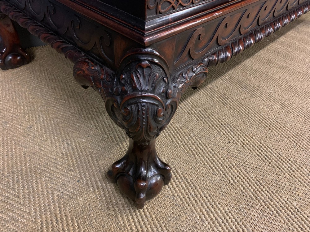 A wide dark mahogany Chippendale style chest featuring four drawers with oval brass handles, carved frieze detailing, and carved ball-and-claw feet. View IX