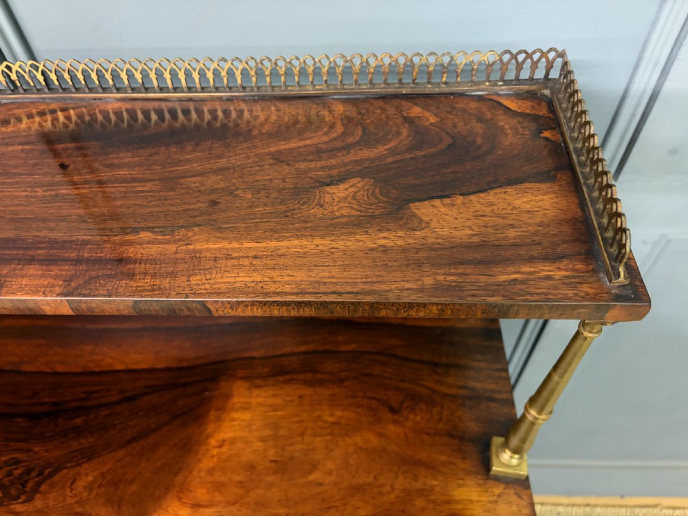A pair of Regency period rosewood side cabinets featuring brass galleries, raised upper shelves, and pleated light green fabric door panels. View VIII