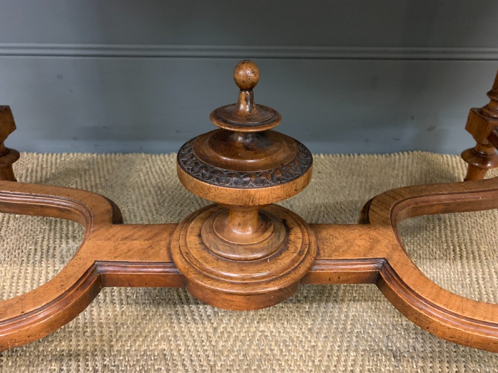 A 19th-century French walnut centre table featuring a parquet veneered top, carved floral frieze, fluted turned legs, and a shaped X-stretcher with a central finial. View V