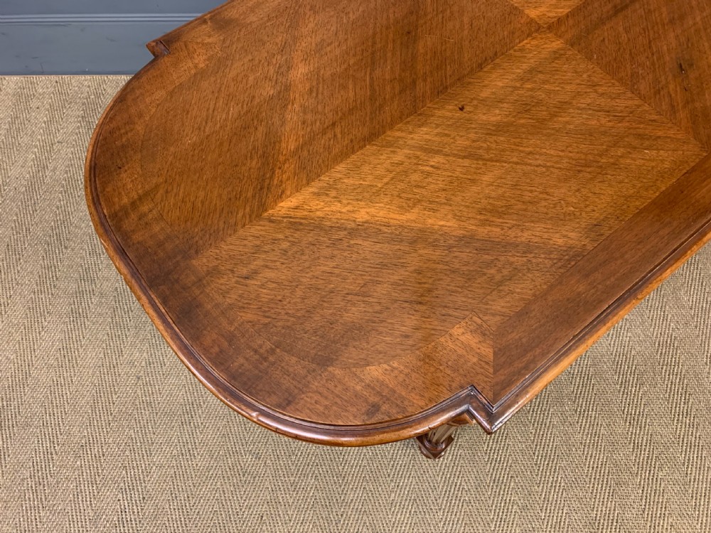 A 19th-century French walnut centre table featuring a parquet veneered top, carved floral frieze, fluted turned legs, and a shaped X-stretcher with a central finial. View XI