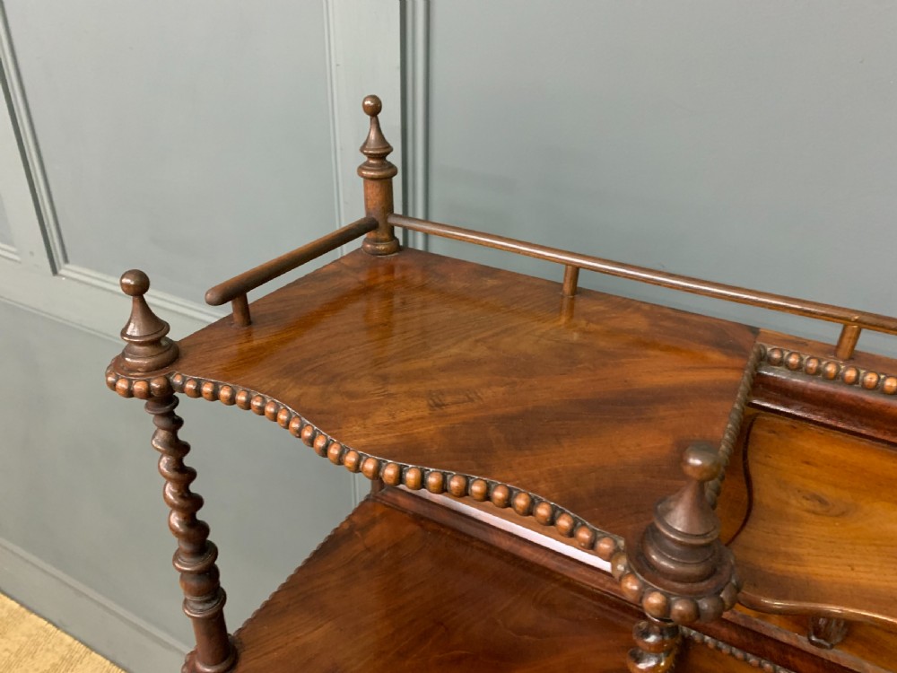 A flame mahogany writing desk featuring carved cabriole legs, a raised superstructure with drawers and gallery shelves, and a curved front with brass keyholes. View VIII