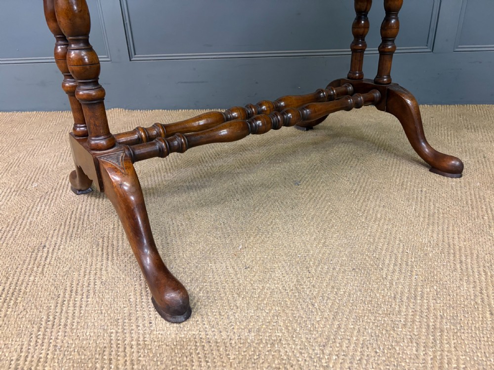A burr walnut sofa table featuring twin drop leaves, two front drawers with brass handles, and double turned stretchers. View XII