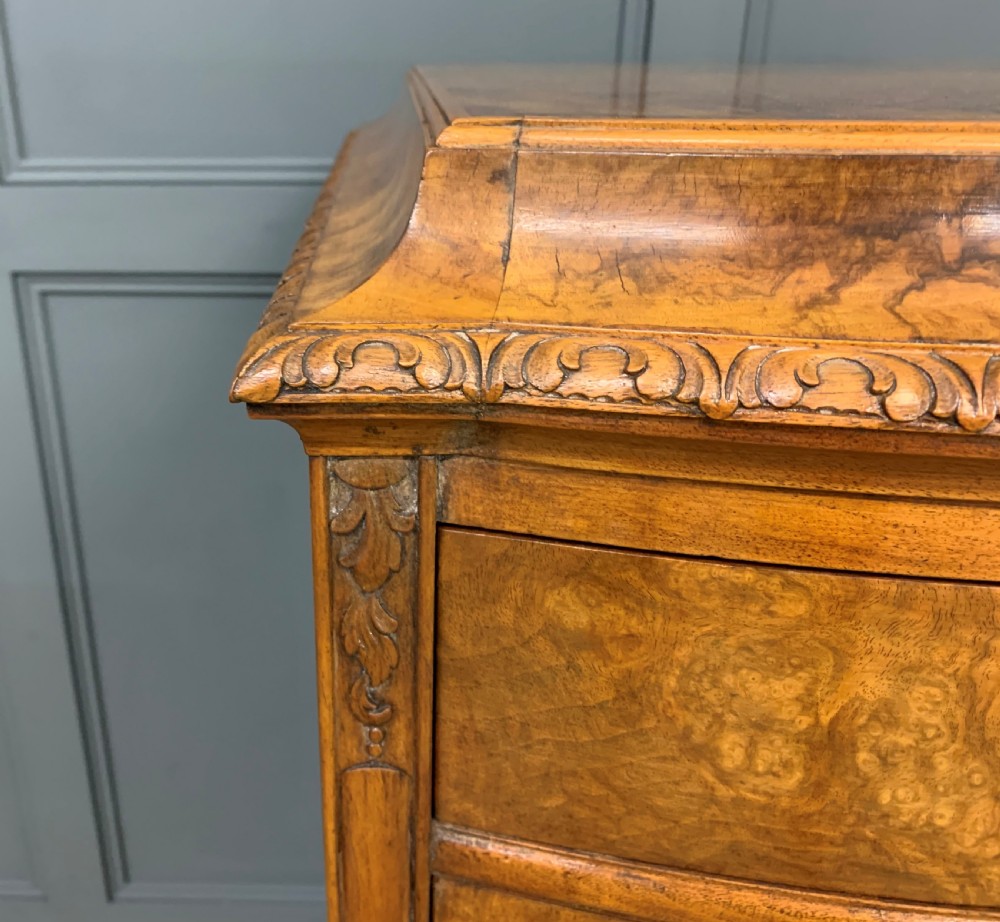 A pair of tall burr walnut pedestal cupboards featuring curved front doors, single top drawers with brass drop handles, and carved scroll feet. View XIII