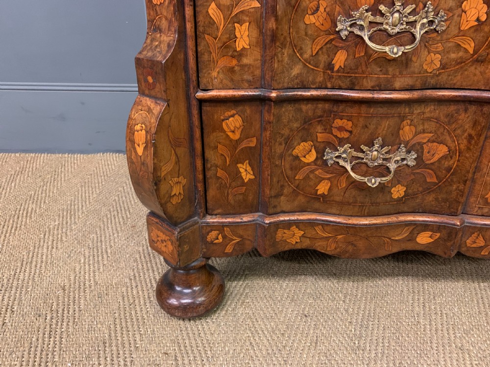 An 18th-century Dutch walnut bureau featuring detailed floral marquetry inlay across the slant-front lid and drawer fronts, accented with brass handles. View III
