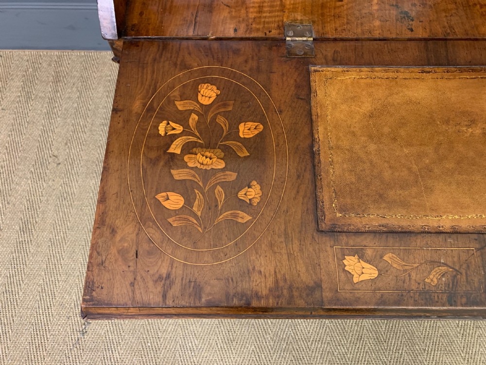An 18th-century Dutch walnut bureau featuring detailed floral marquetry inlay across the slant-front lid and drawer fronts, accented with brass handles. View XI